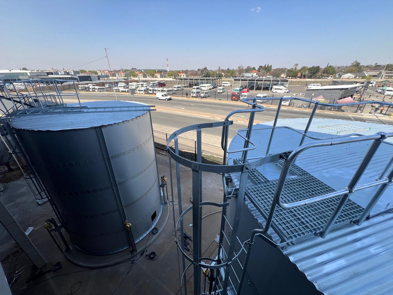Cylindrical steel water storage tank with access platform and safety cage at East Rand Mall, Boksburg